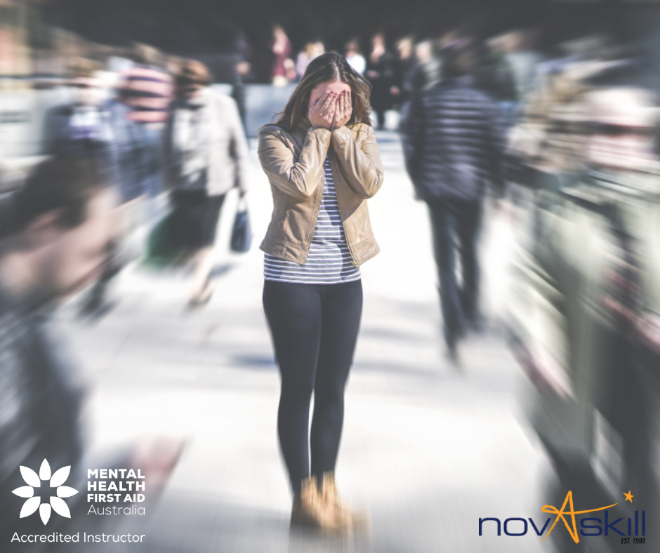 Mental Health First Aid message showing a distressed person in a busy crowd
