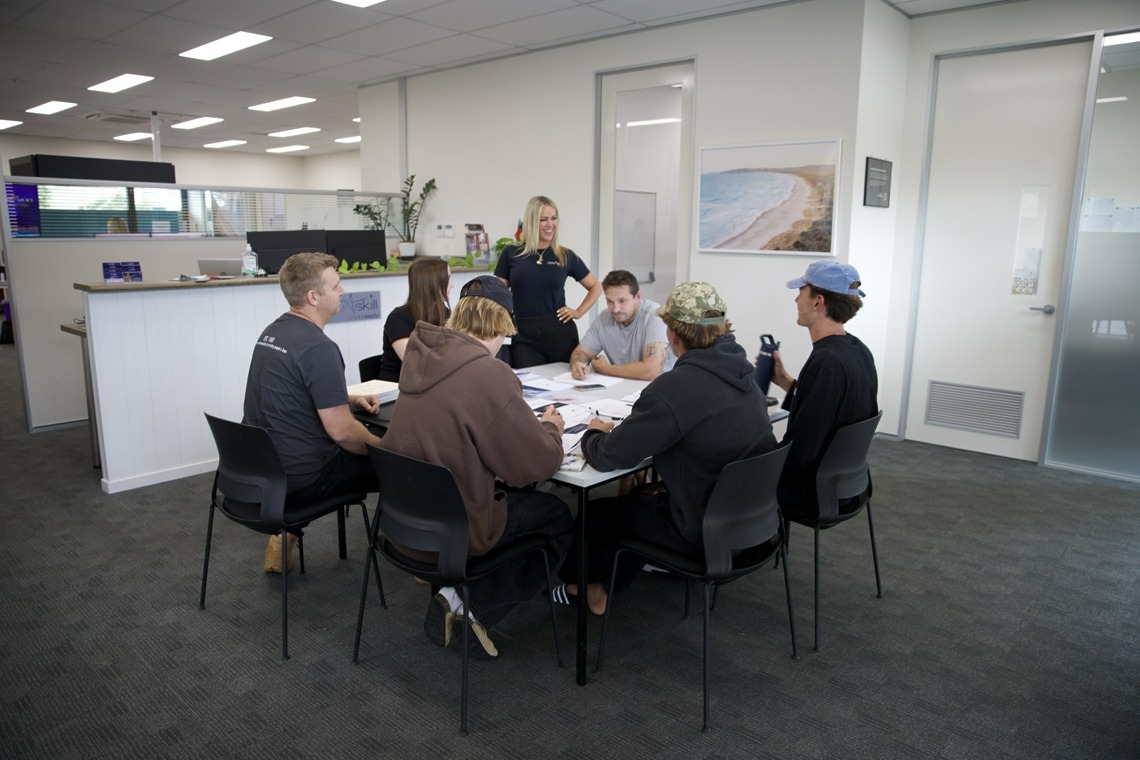 Novaskill trainer working with students around a table